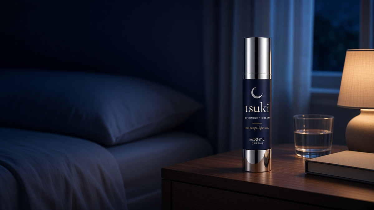 tsuki overnight cream on a bedside table at night, lamp on