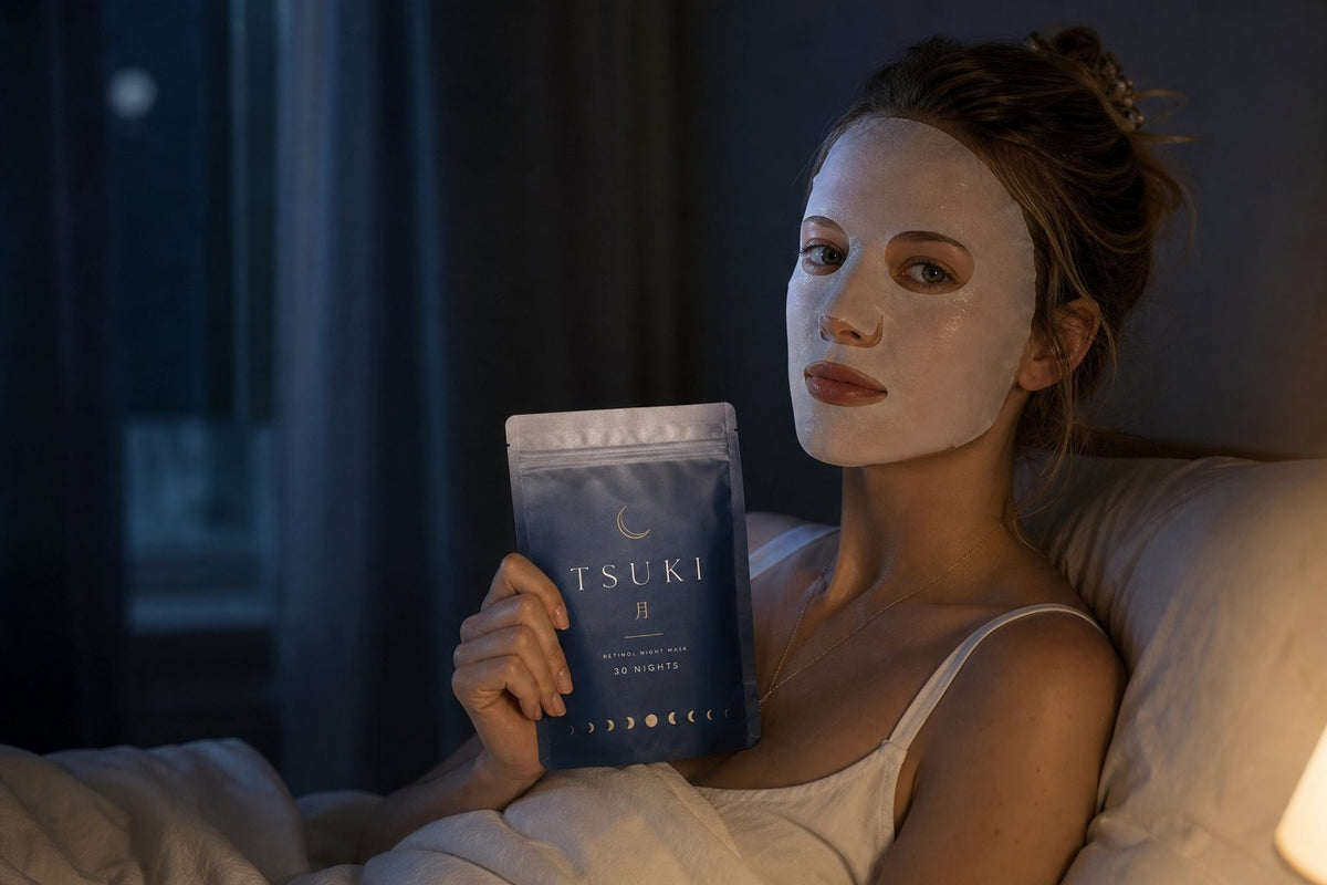 girl in bed wearing a tsuki sheet mask, holding the indigo pouch